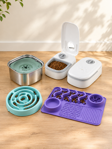 A pet feeding and enrichment set arranged on a light wood floor against a beige wall. The set includes a stainless steel bowl with a turquoise lid, two white automatic feeders (one open showing kibble, one closed), a turquoise maze feeder plate, and a purple slow feeder mat with bowls and textured sections.